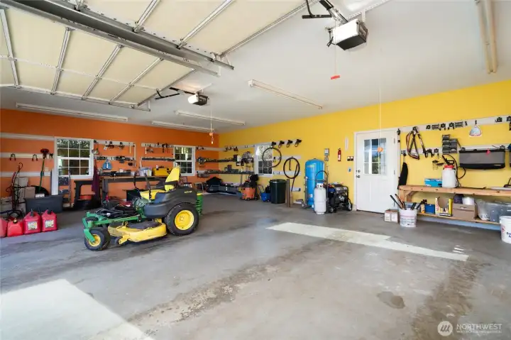 Large separate two-car garage with shop area and covered walkway to house. Recently serviced garage doors. Generator with new 2025 wiring for full house and water system.