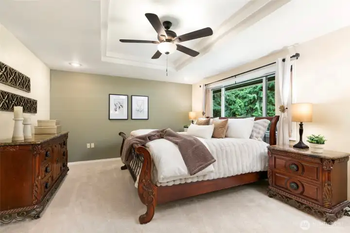 Primary bedroom has ceiling fan and Coffered ceiling.