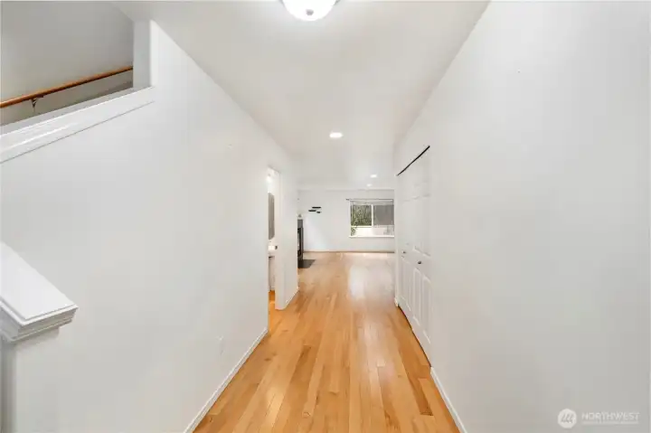 Inviting hardwood floored hallway leads to the cozy Living Room…