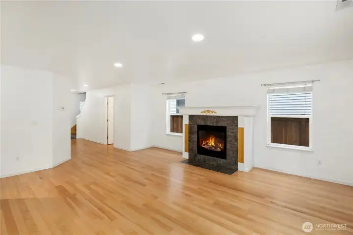 …Sunlit Living Room with accesses to kitchen and formal Dining Room.