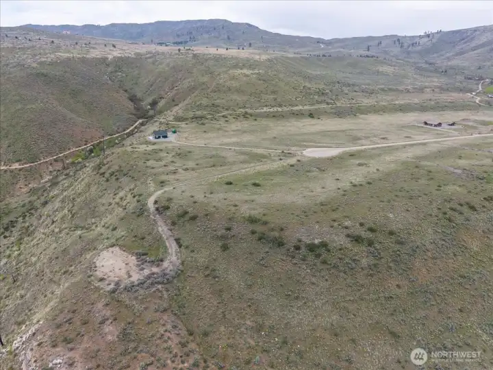 Expansive 9.8+ acre lot offering a premier 3-acre building pad on the bluff, plus a bonus lower-level site—perfect for a shop or guest house