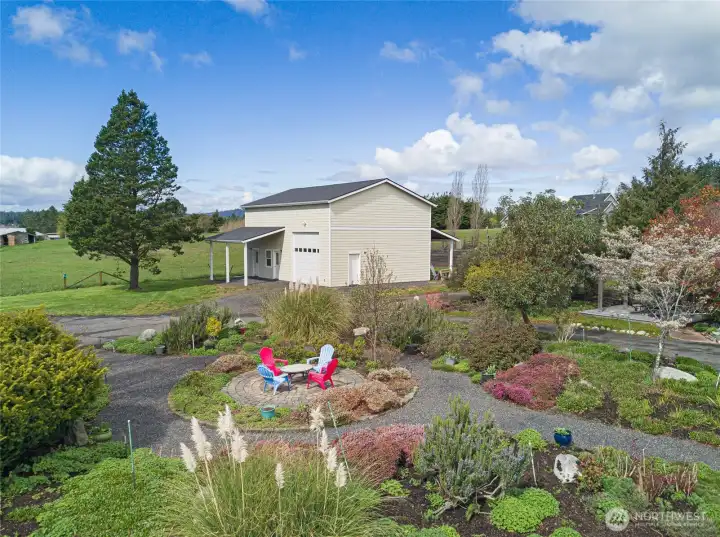 Garden and large shop view with extra tall garage door for RV storage