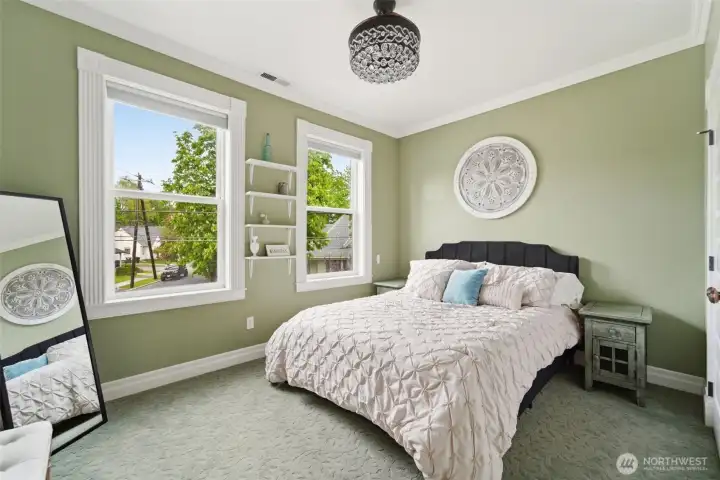 Spacious bedroom with stylish chandelier fan