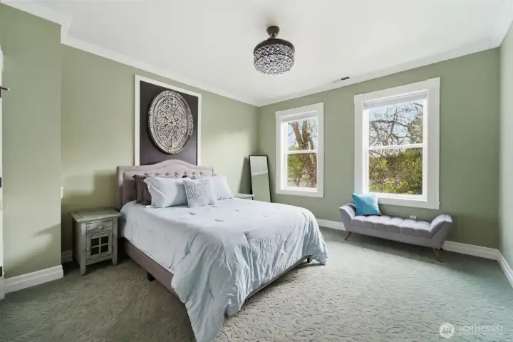 Spacious bedroom with stylish chandelier fan. Open the window to enjoy the calming sound of your very own creek in the backyard