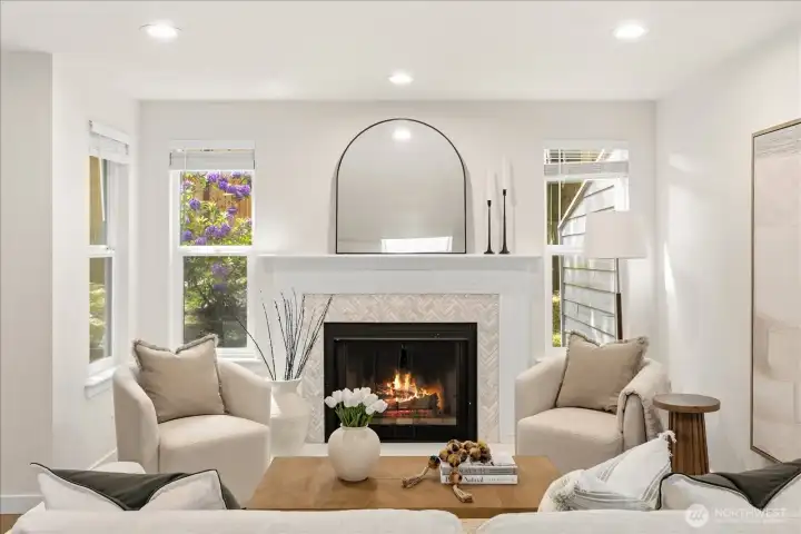 The living room is  anchored by a wood-burning fireplace with a brand-new quartz & tile surround.