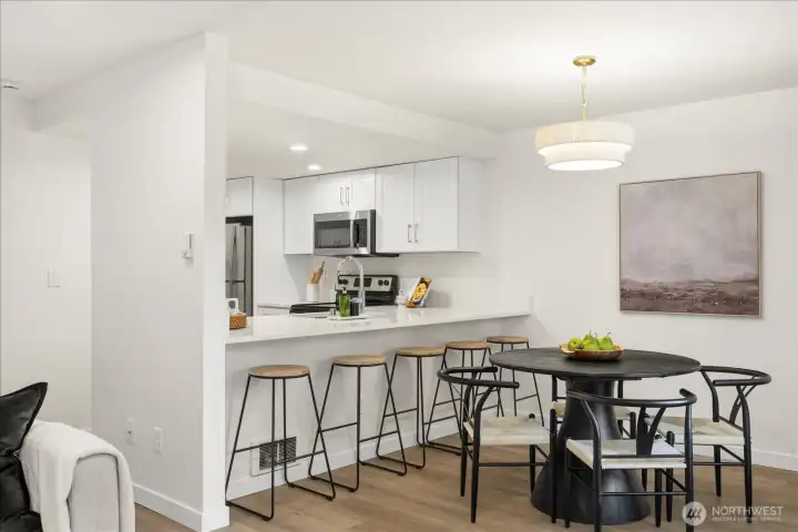 Generous breakfast bar seating creates the perfect perch for casual meals, homework, or catching up with guests while dinner is underway.