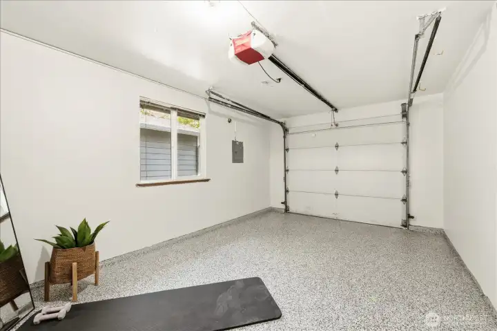 Garage updated with fresh paint and epoxy flooring, creating a clean and flexible extension of the home.