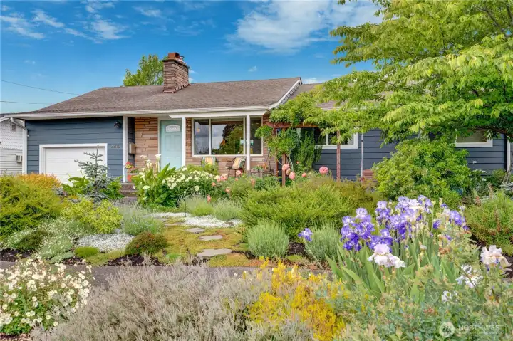 The kind of Mid-Century stunner you simply move right into and start living your best life. Lush, beautifully curated gardens surround the home with hidden alcoves, flagstone patios, and fragrant blooms that create a private outdoor escape.