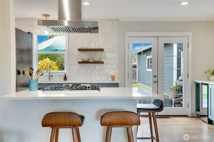 Designed with the perfect flow for everyday living and entertaining, this beautifully updated space features upgraded appliances, stylish open shelving, and abundant storage throughout.