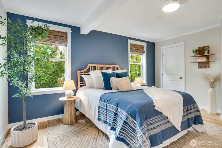 The spacious primary suite features dual closets, including a walk-in closet, along with a private bath offering dual vanities and a gorgeous custom-tiled shower. Custom blinds throughout the home add both style and comfort.