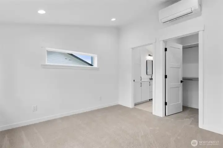 Primary bedroom with ensuite bath and walk-in closet