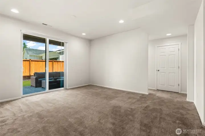 Daylight basement living space leading onto covered ground floor patio.