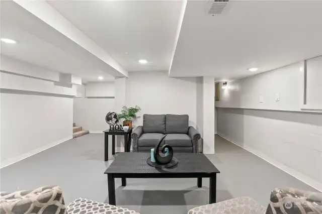 View of the Basement facing the stairs and Mechanical Room w/Furnace and Hot Water Heater.