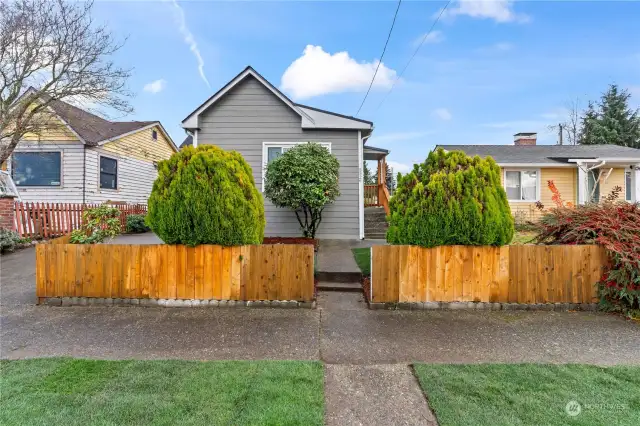 A bit further back shows the sidewalks. Remodeled neighboring home on the right and the neighboring home to the left is mid-remodel as well. Nicely kept neighborhood!