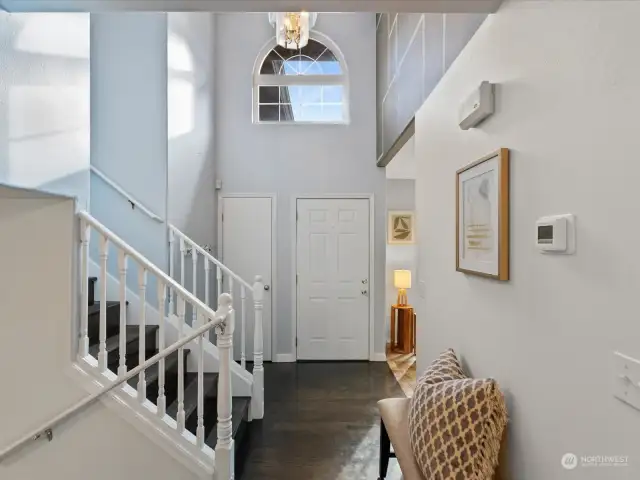 Vaulted entrance with stairs up to bedrooms & down to family room