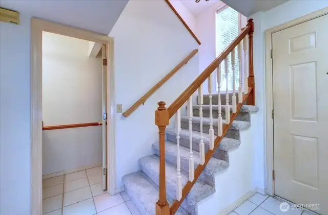 Entry area with access to second floor. Main door to the right. Half bath straight ahead. Garage door to the far right (out of range of the picture).