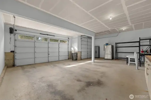 Spacious 3 car garage with one bay available for RV or Boats