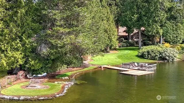 Frank Lloyd Wright inspired Pine Lake home on nearly an acre features 118' of waterfront. A year-round delight of stunning architecture and nature.