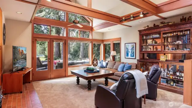 Wood-stained French Doors and large windows provide stunning views of the lake.