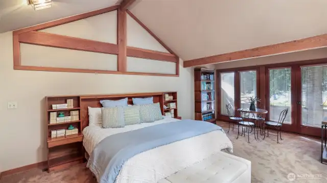 Primary suite located in its own wing with private deck sporting serene views of the lake.