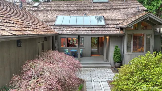 The covered front porch provides additional space to enjoy the lush landscape of this exceptional property.
