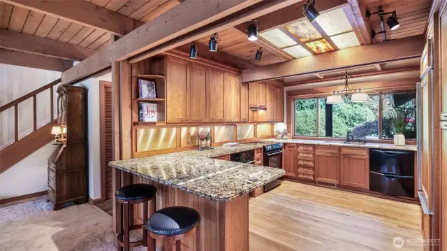 Custom remodeled kitchen with cherry cabinetry and glass paneled ceiling.