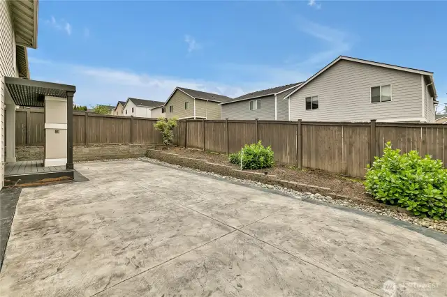 The poured concrete patio is great for scooters, skates, or a ton of sun chairs!