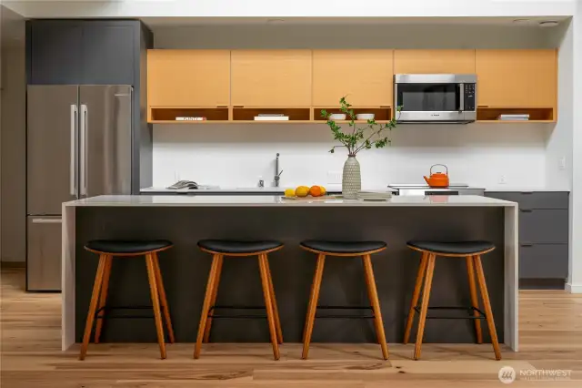 The kitchen is a chef's dream, featuring elegant quartz countertops, high-end Bosch appliances, an induction stove, and Abodian cabinetry, which offers ample storage space for all your culinary needs.