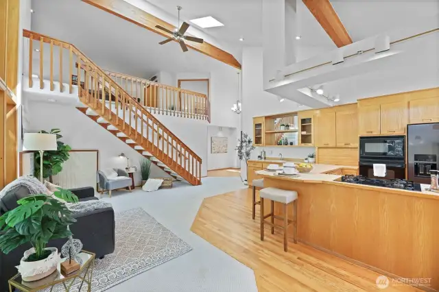 Open-concept family room and kitchen complete with island seating and wet bar.