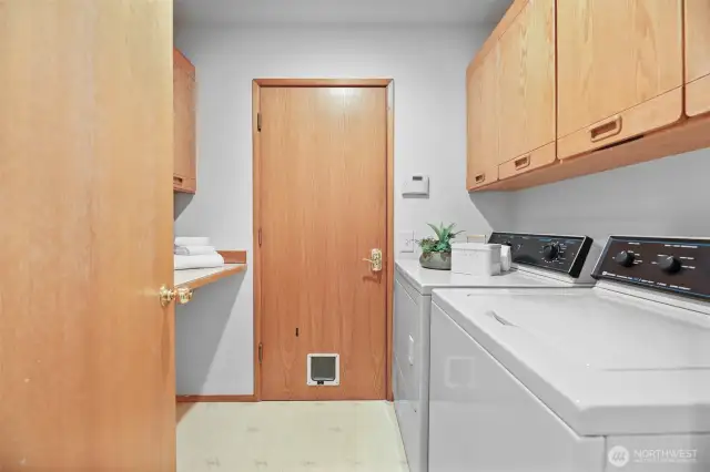 Utility room complete with a sink, washer, dryer and access to the large 3-car garage.