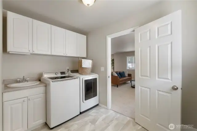 Large utility room with sink & cabinet space.