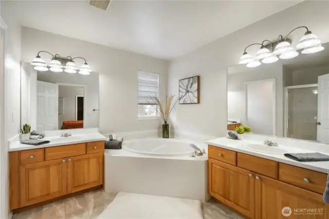 Primary spa-like bath w/ dual sinks, soaking tub & separate shower.