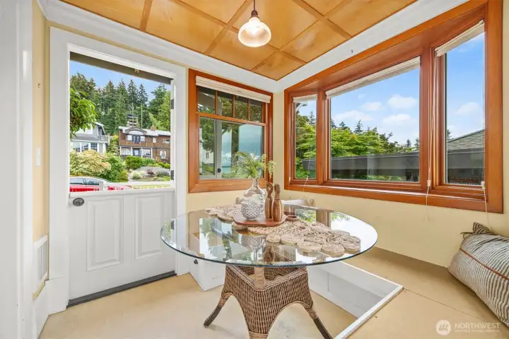 Exterior entry with a Dutch door on the street, east, side of the breakfast room. There's a deck on the west side with gas for a BBQ.