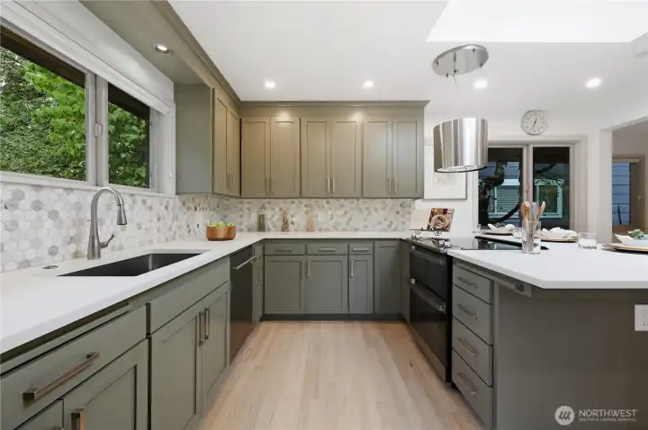 Open concept kitchen offering quartz counters and generous cabinetry.
