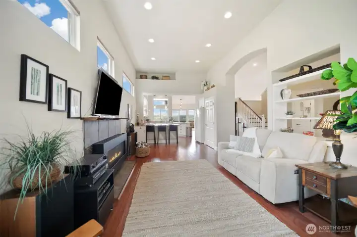 The living room seamlessly transitions into a spacious open-concept kitchen with eat in bar.