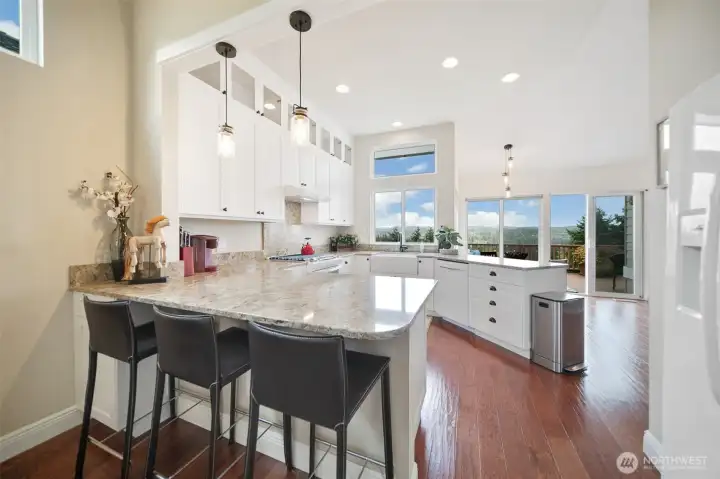 The charming eat-in kitchen welcomes you with a seamless flow.