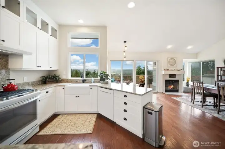 A stylish farmhouse sink elevates the kitchen, which flows effortlessly into a cozy dining nook and relaxed family room.