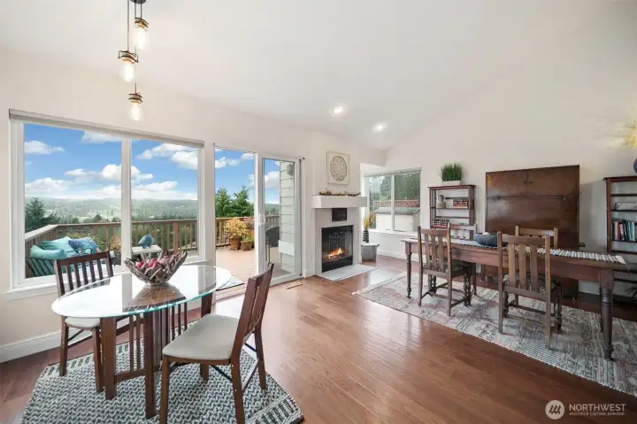 The area adjacent to the kitchen provides versatile dining possibilities, with the far left space adaptable for various uses, such as a generous sitting area to relax by the wood-burning fireplace.
