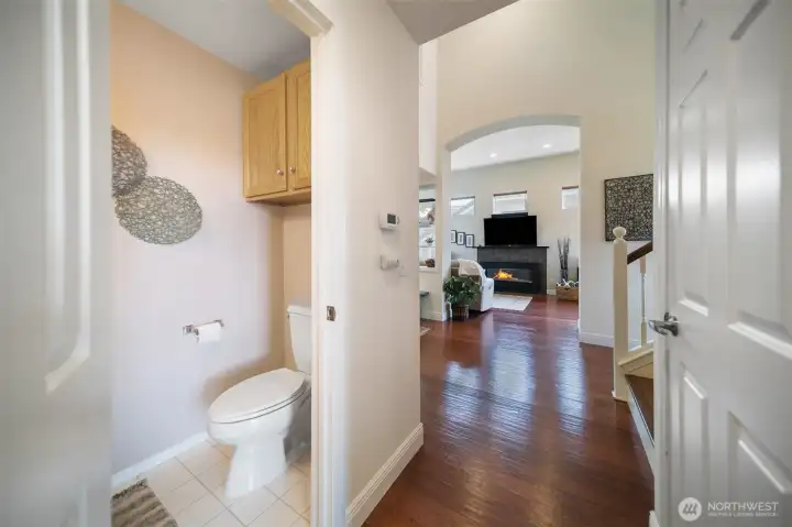 A thoughtfully placed quarter bathroom offers extra comfort and convenience for your guests.
