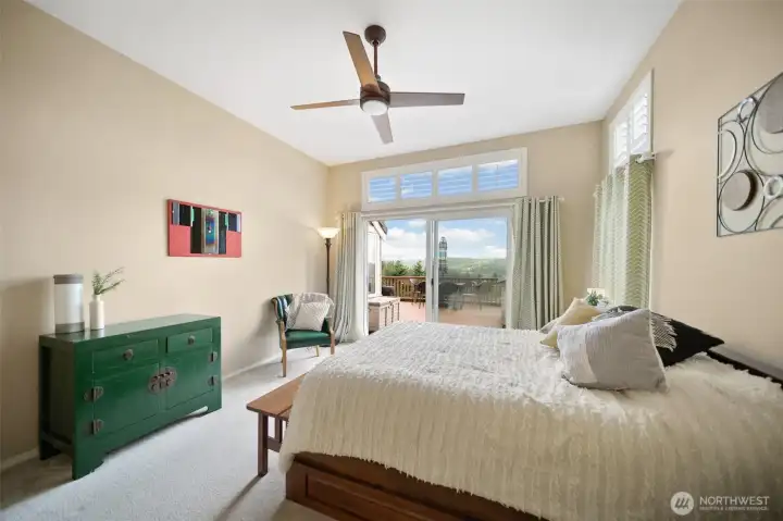 Returning to the expansive primary bedroom, enjoy the view toward the deck access, inviting the outdoors in.