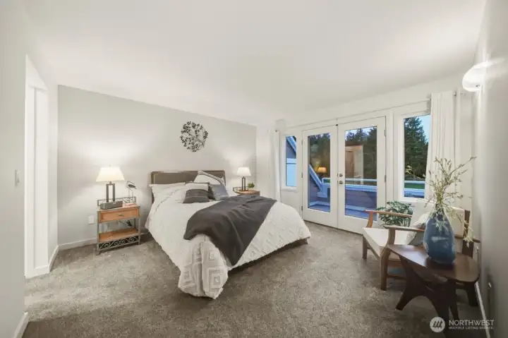 The spacious main-floor primary suite features elegant French doors opening to a serene private balcony—offering second-story security.