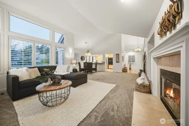 Returning to the great room, this breathtaking perspective highlights soaring cathedral ceilings that infuse the space with dramatic dimension and captivating architectural interest.