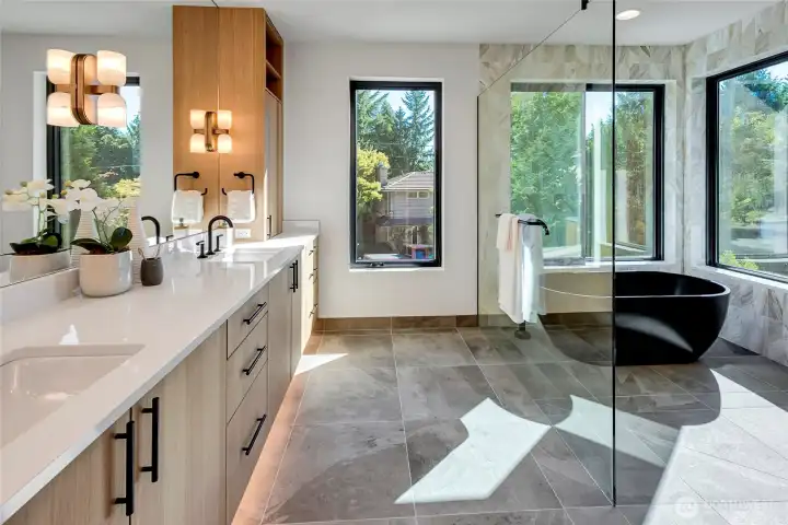 Fabulous primary bath is truly like a spa at the Four Seasons.  Under cabinet lighting, slab quartz, soaking tub and Double headed shower.