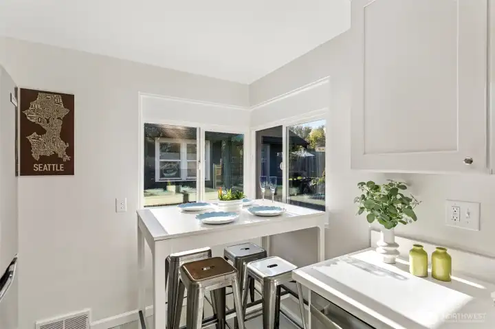 Just off the living room, the kitchen offers a bright corner eating space with natural light from multiple windows.