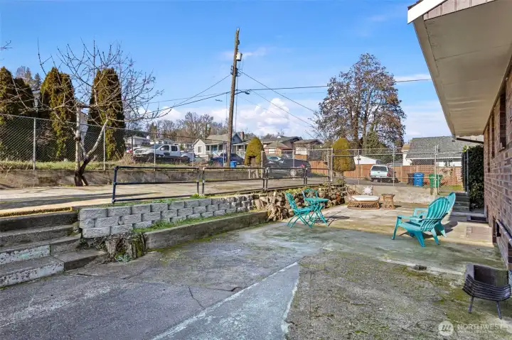 A generous concrete patio with western exposure, well suited for outdoor dining, grilling, and gathering, with flexibility to personalize over time.