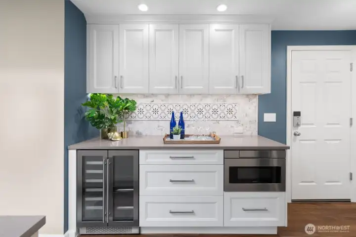 Built-in beverage station with wine refrigerator and microwave.
