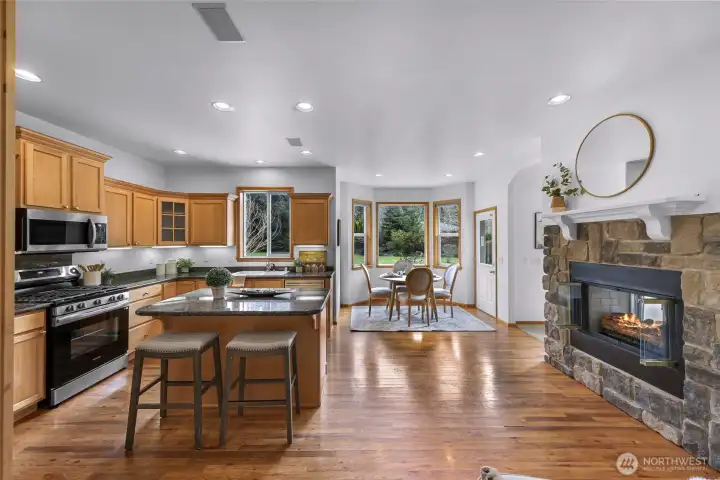 Functional kitchen layout with granite countertops and hardwood floors