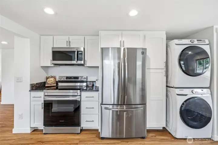 Another view of the kitchen. The door to the basement is just to the right of the washer and dryer.