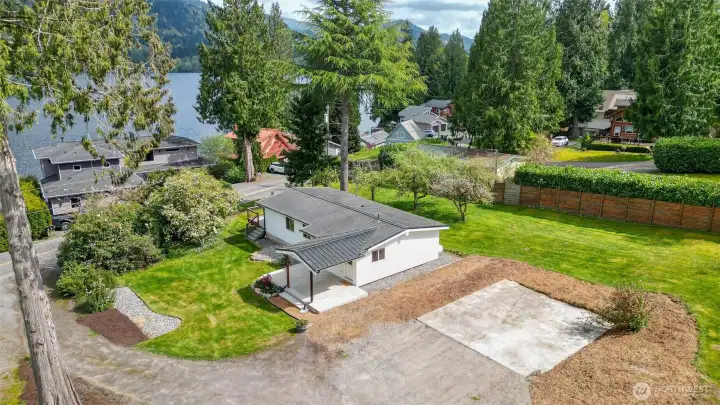 The concrete pad is for parking and could potentially accommodate the construction of a carport or detached garage. Buyer to verify.