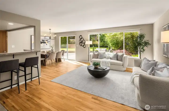 The main level features an inviting open-concept layout with seamless flow between the kitchen, dining, and living spaces, all opening to expansive outdoor entertaining areas.